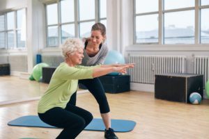 Elderly Woman Doing Exercise With Her Personal Trainer
